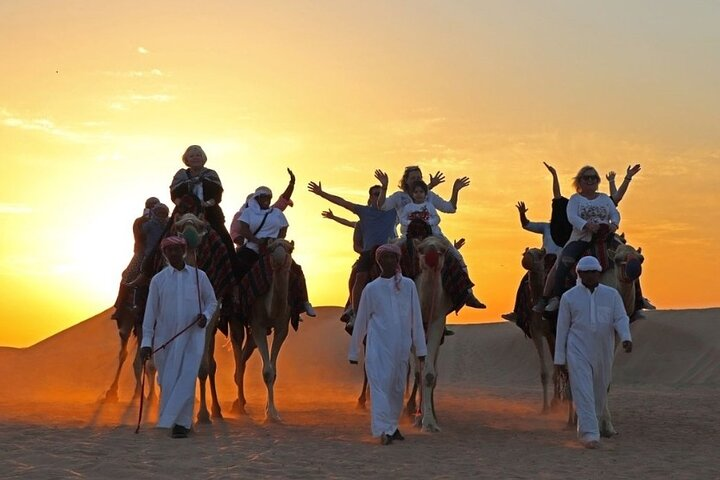 Experience the magic of the Dubai desert at sunrise riding camels amid soft sands and traditional Bedouin hospitality creating lasting memories of adventure and culture.